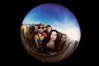 a group of people standing in front of a mirror