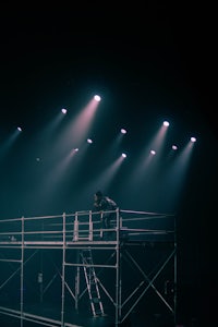 a person standing on a platform in a dark room