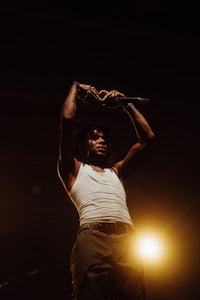 lil wayne on stage with his hands in the air