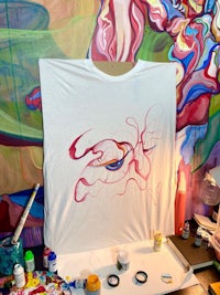 a white t - shirt with a painting on it