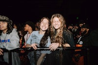 two girls smiling at a crowd of people