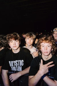 a group of young people standing in front of a crowd