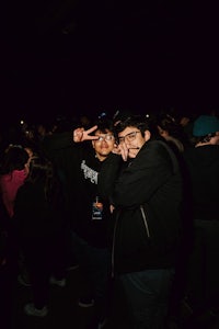 two men posing for a picture in a crowd